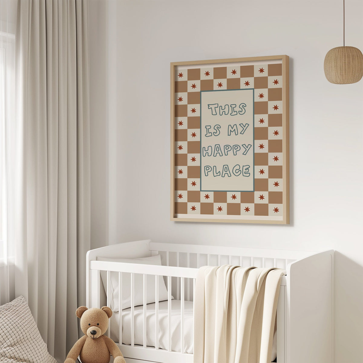 This is my happy place nursery print in an oak frame above a white crib with a teddy bear