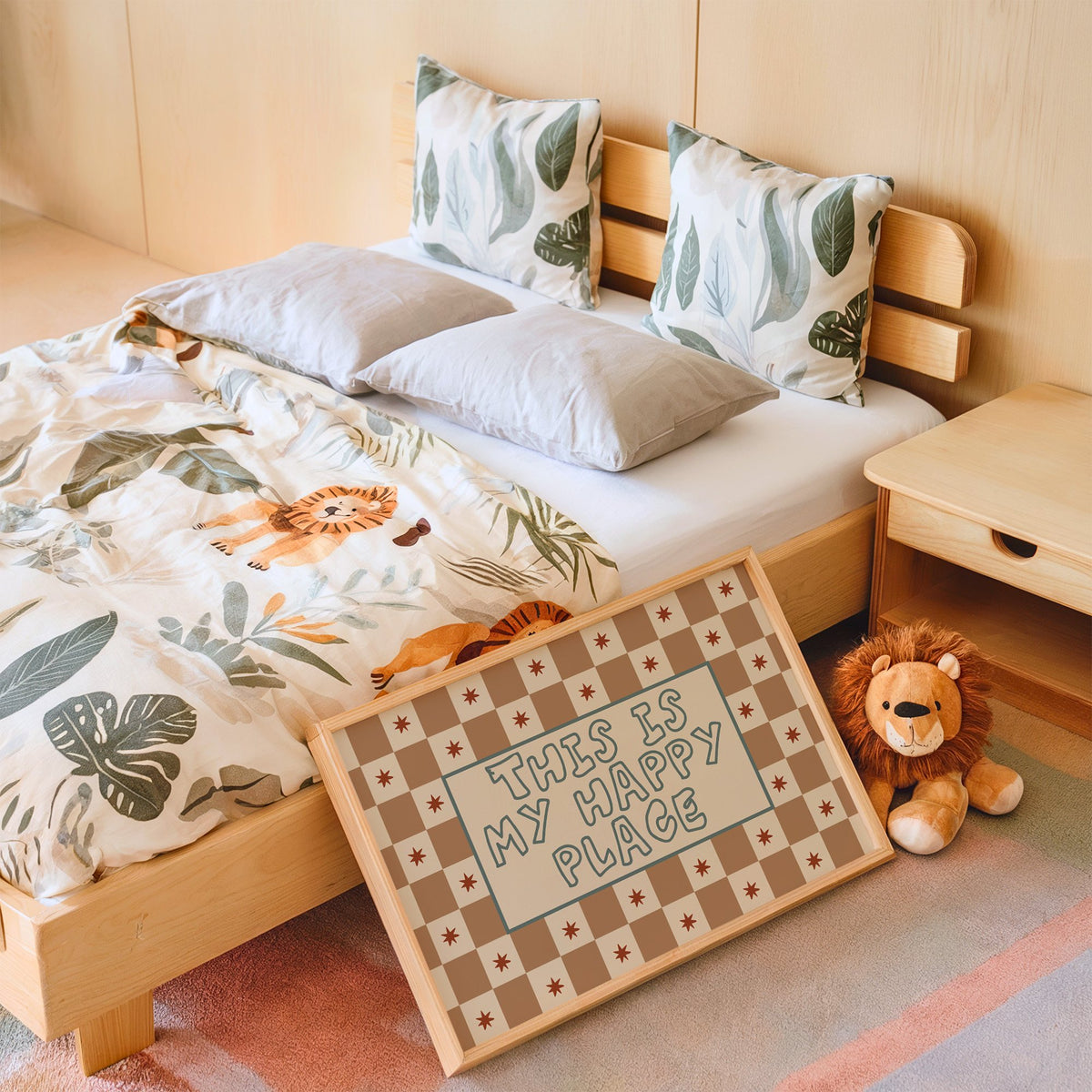 Landscape this is my happy place nursery print in an oak frame leaning on a kids bed by a lion plush