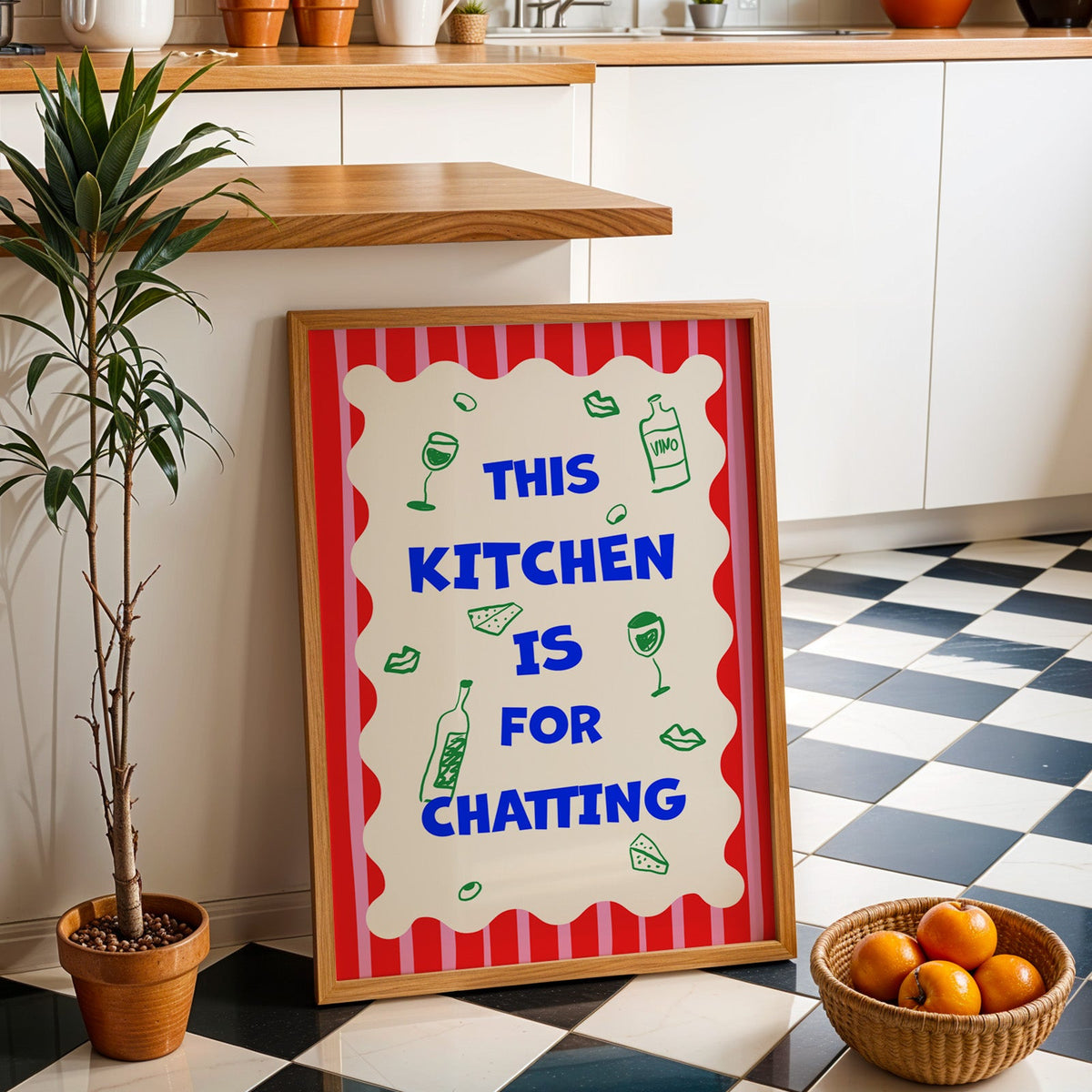 This kitchen is for chatting print in an oak frame by a kitchen island and tiled floor
