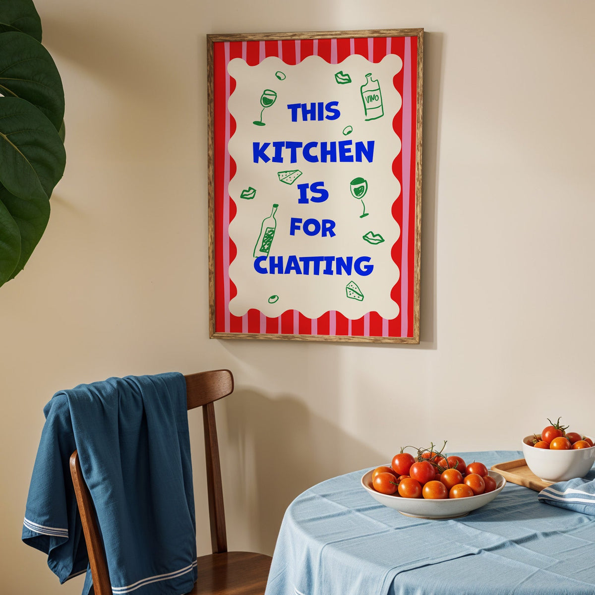 This kitchen is for chatting print in an oak frame above a blue linen table