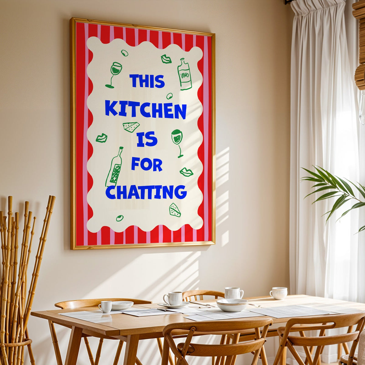 This kitchen is for chatting print in a gold frame above a sunlit breakfast table