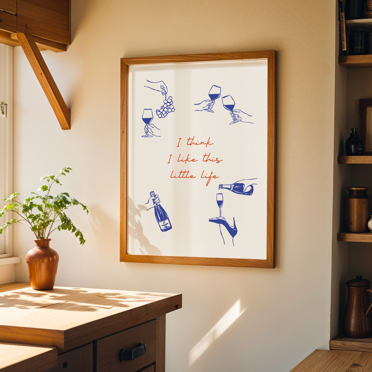 This Little Life wine print in a walnut frame on a cream kitchen wall