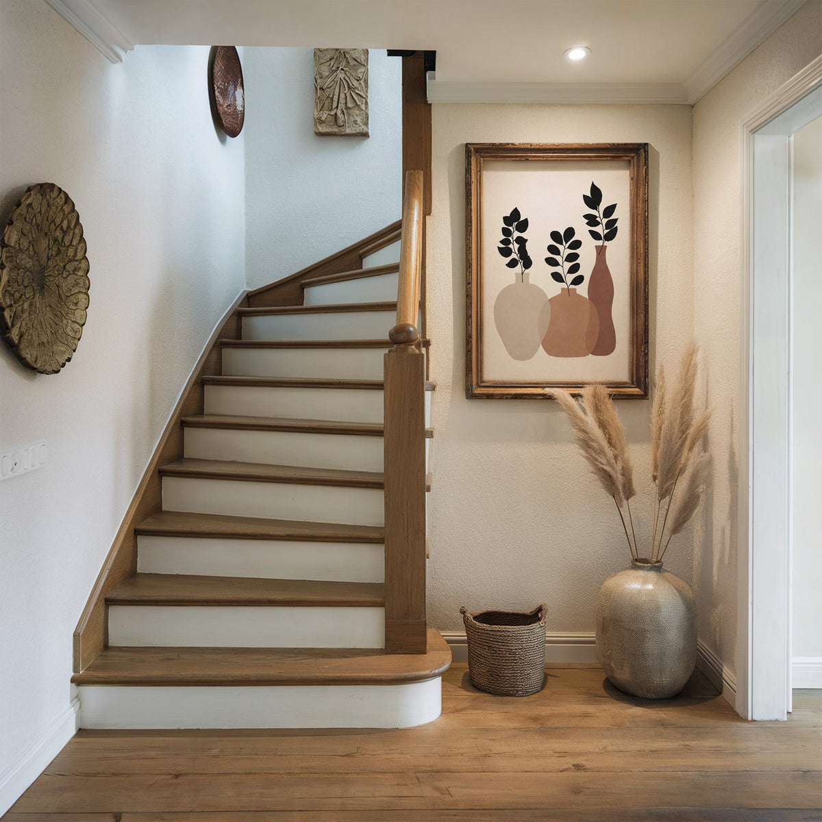 Three earth tone vases with black sprigs print shown in a rustic wood frame in a hallway beside a wooden staircase