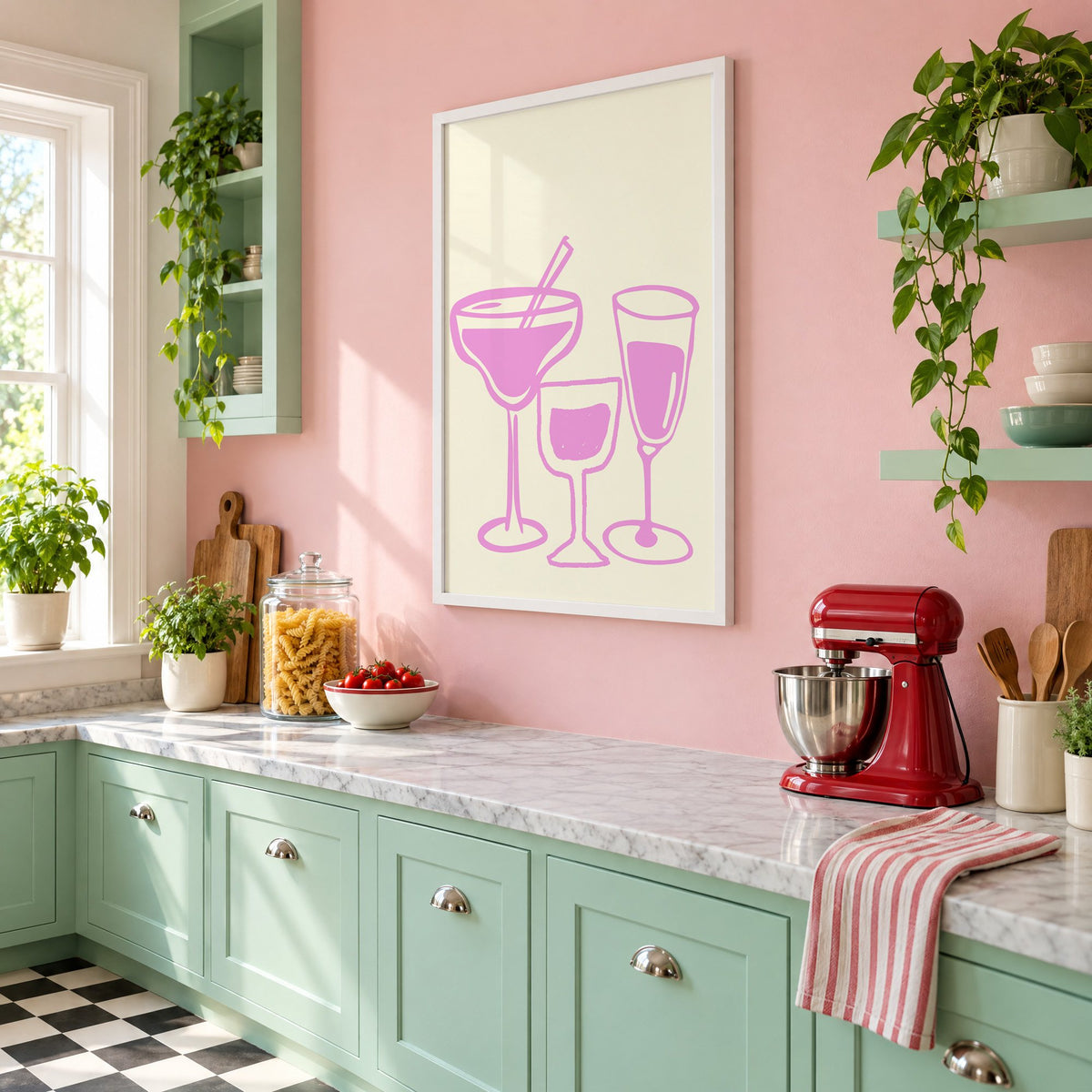 Three pink cocktail glasses linocut-style print in a white frame on a pink wall above mint green cabinets in a retro kitchen, seen at an angle
