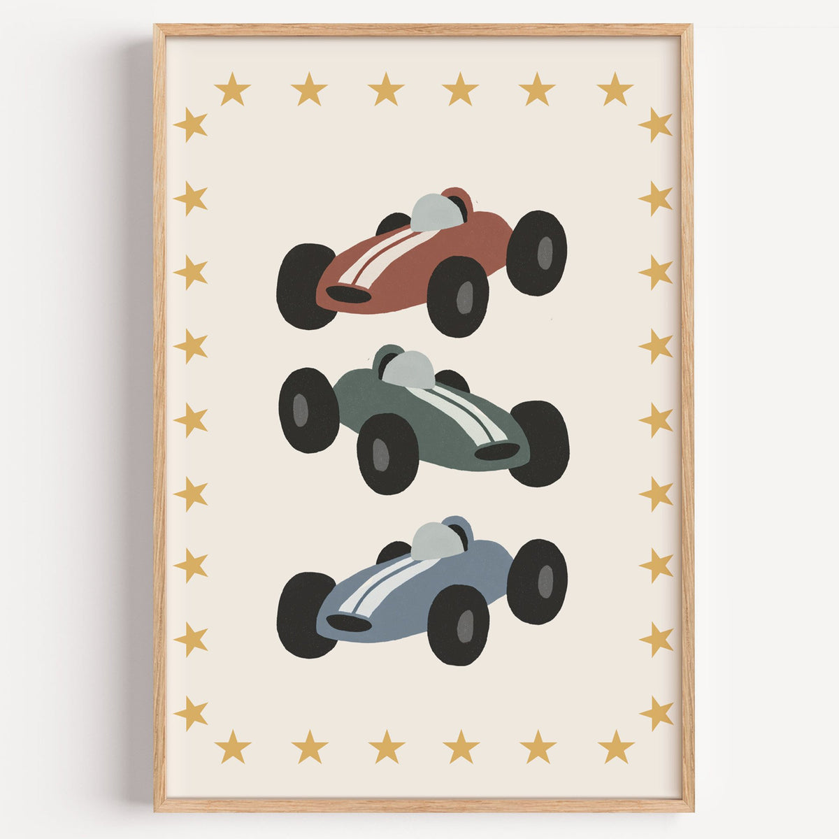 Three race cars star border nursery print in a light oak frame on a plain white wall