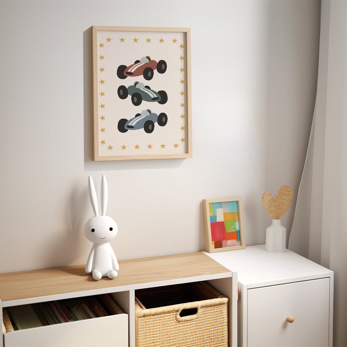 Three race cars star border nursery print in an oak frame above a kids cubby shelf with a woven basket and bunny lamp
