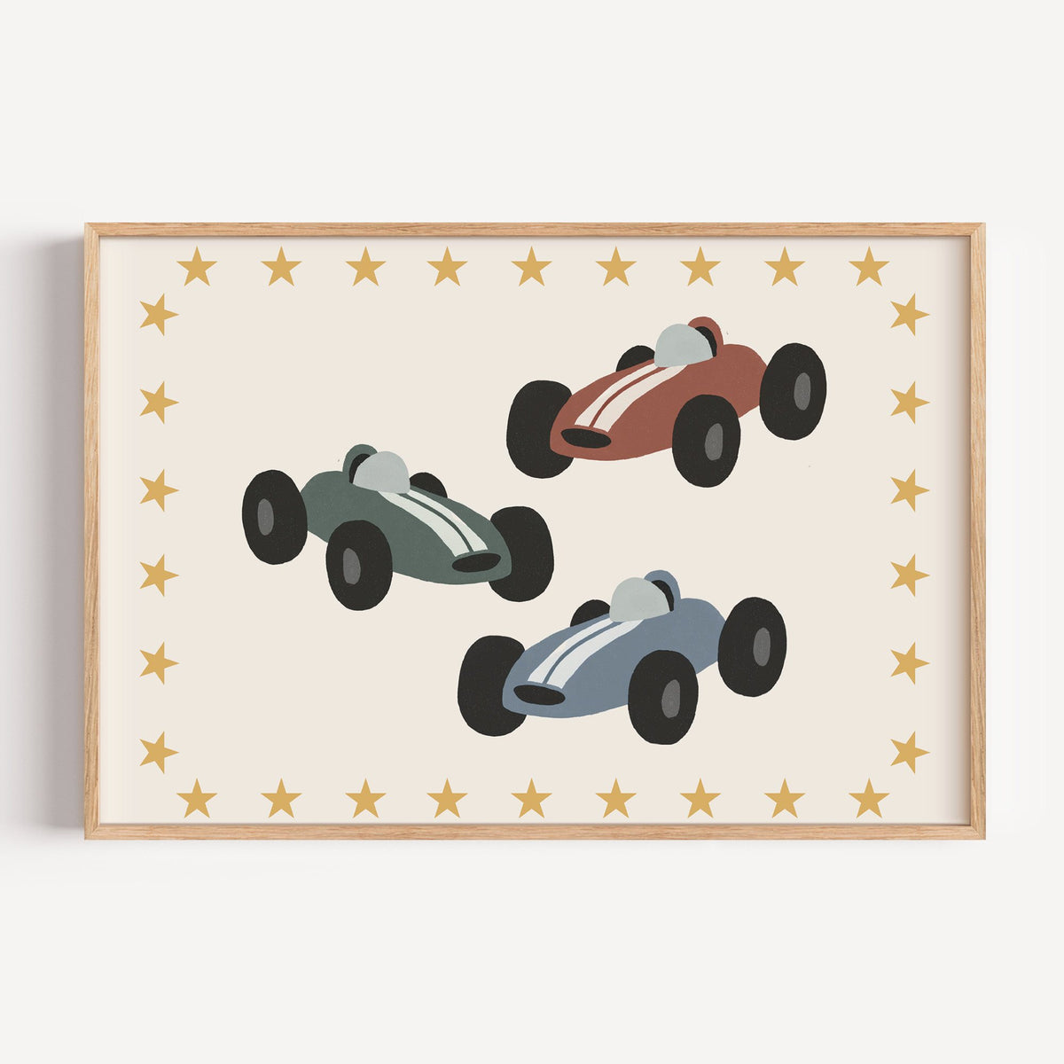Landscape three race cars star border nursery print in a light oak frame on a plain white wall