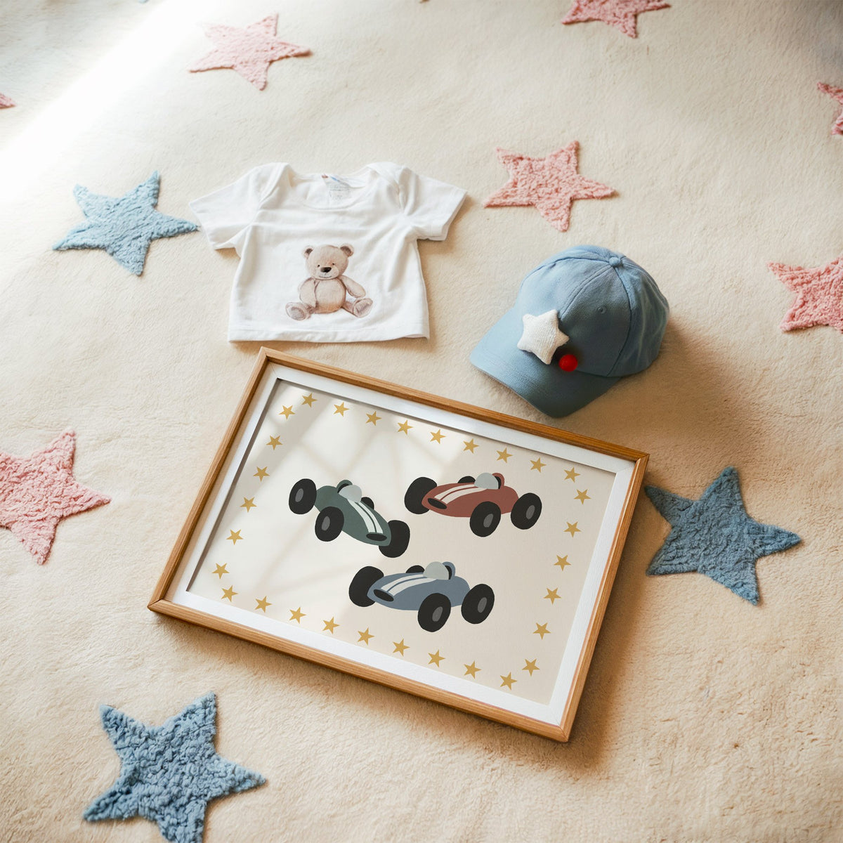 Landscape three race cars star border nursery print in a matted oak frame on a star rug with a baby tee