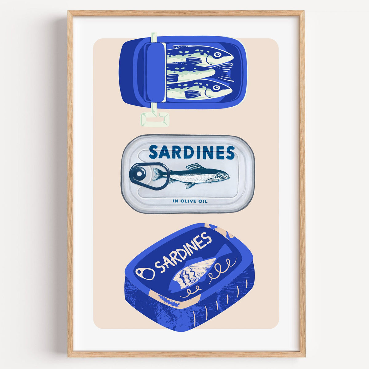 Three sardine tins cobalt print in a light oak frame on a plain white wall
