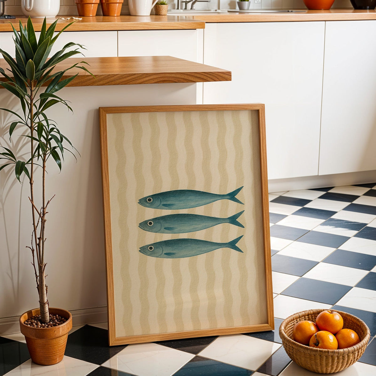 Three vintage sardines print in an oak frame by a kitchen island and checkered floor