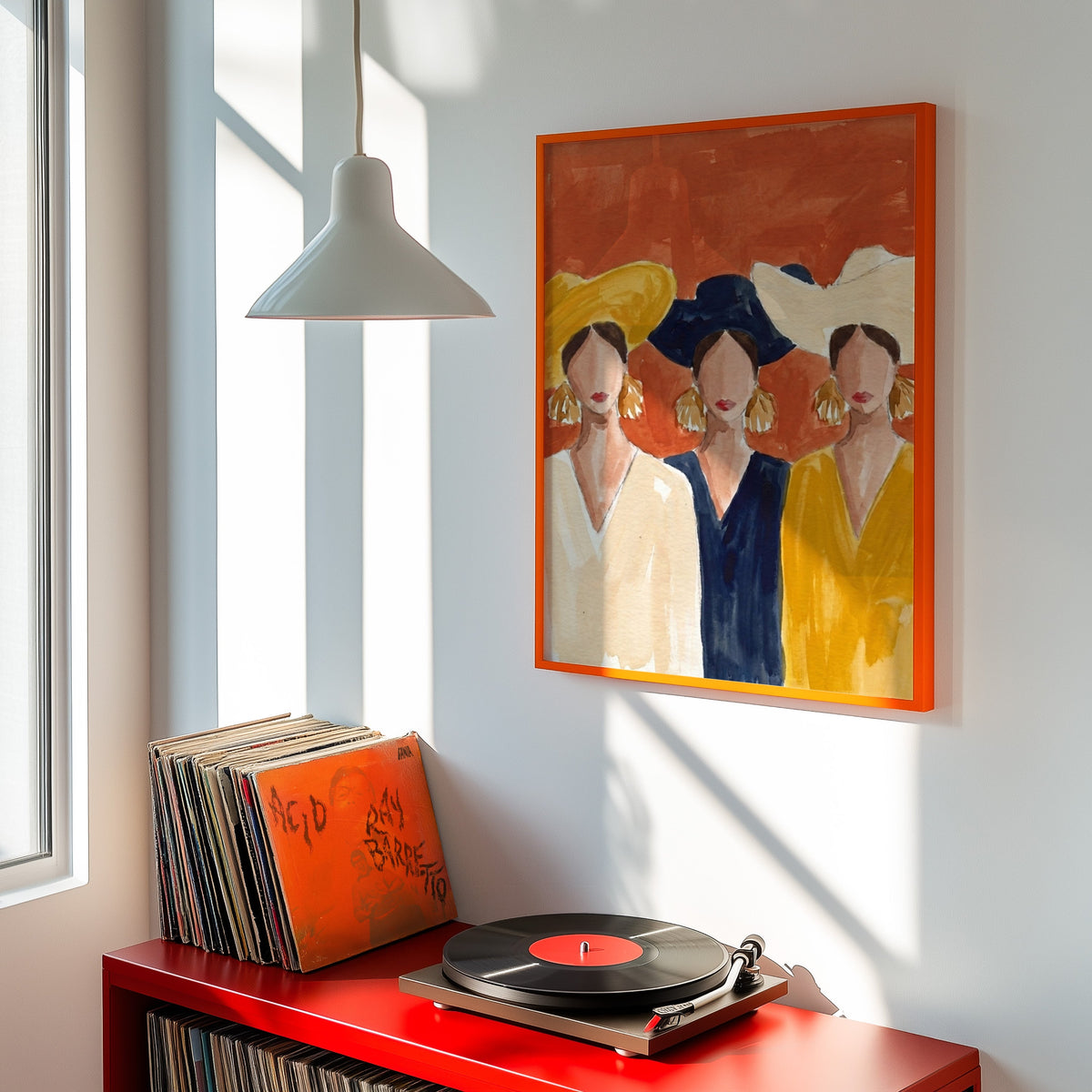 Faceless women portrait print shown in an orange frame above a red record cabinet and turntable