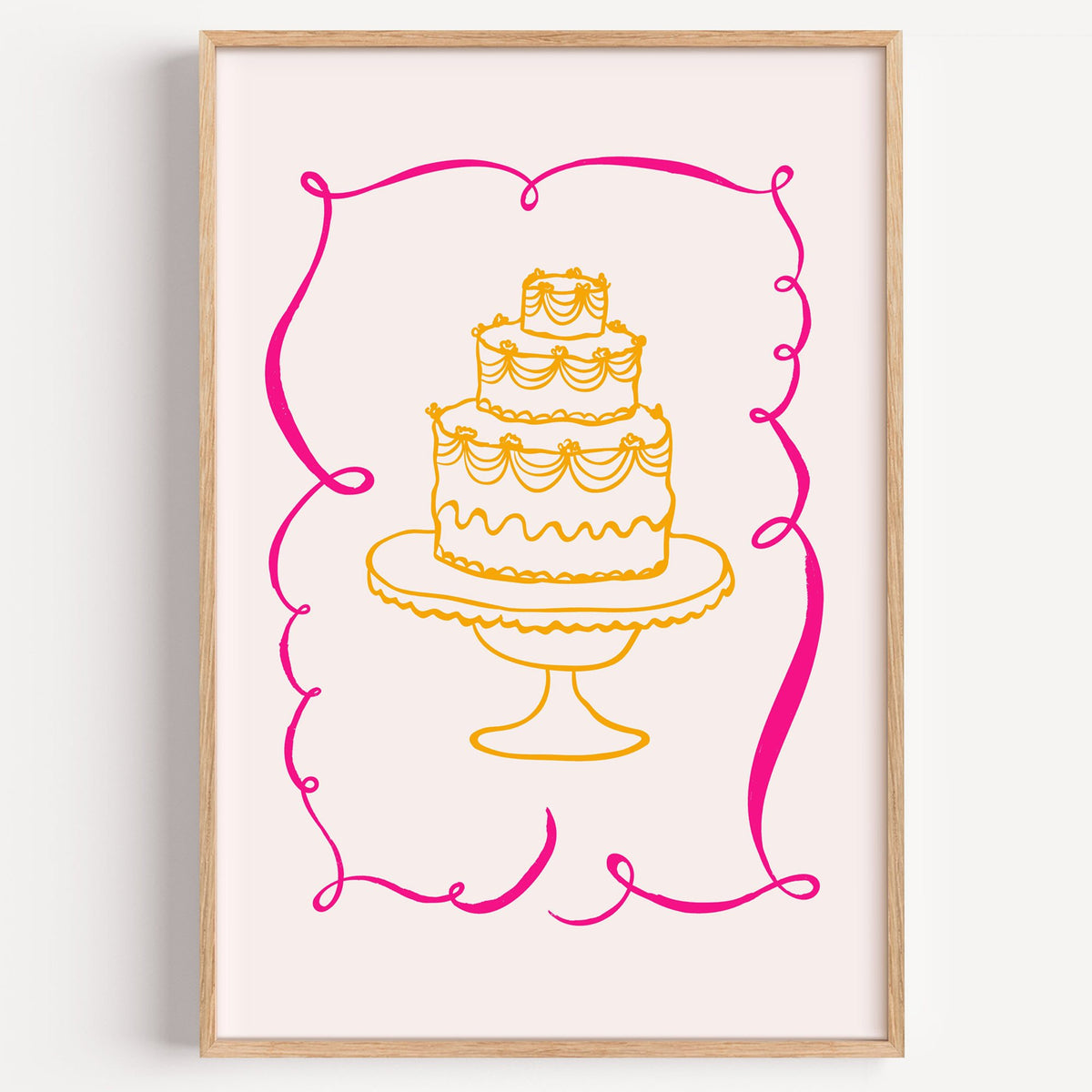Tiered cake pink ribbon frame print in a light oak frame on a plain white wall