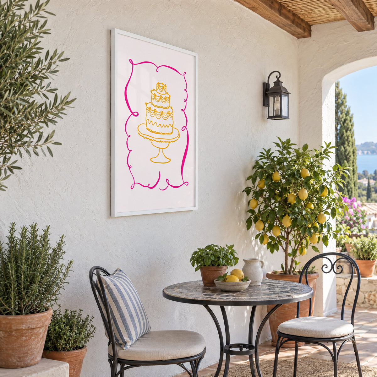 Tiered cake pink ribbon frame print in a white frame on a sunny patio wall beside a potted lemon tree