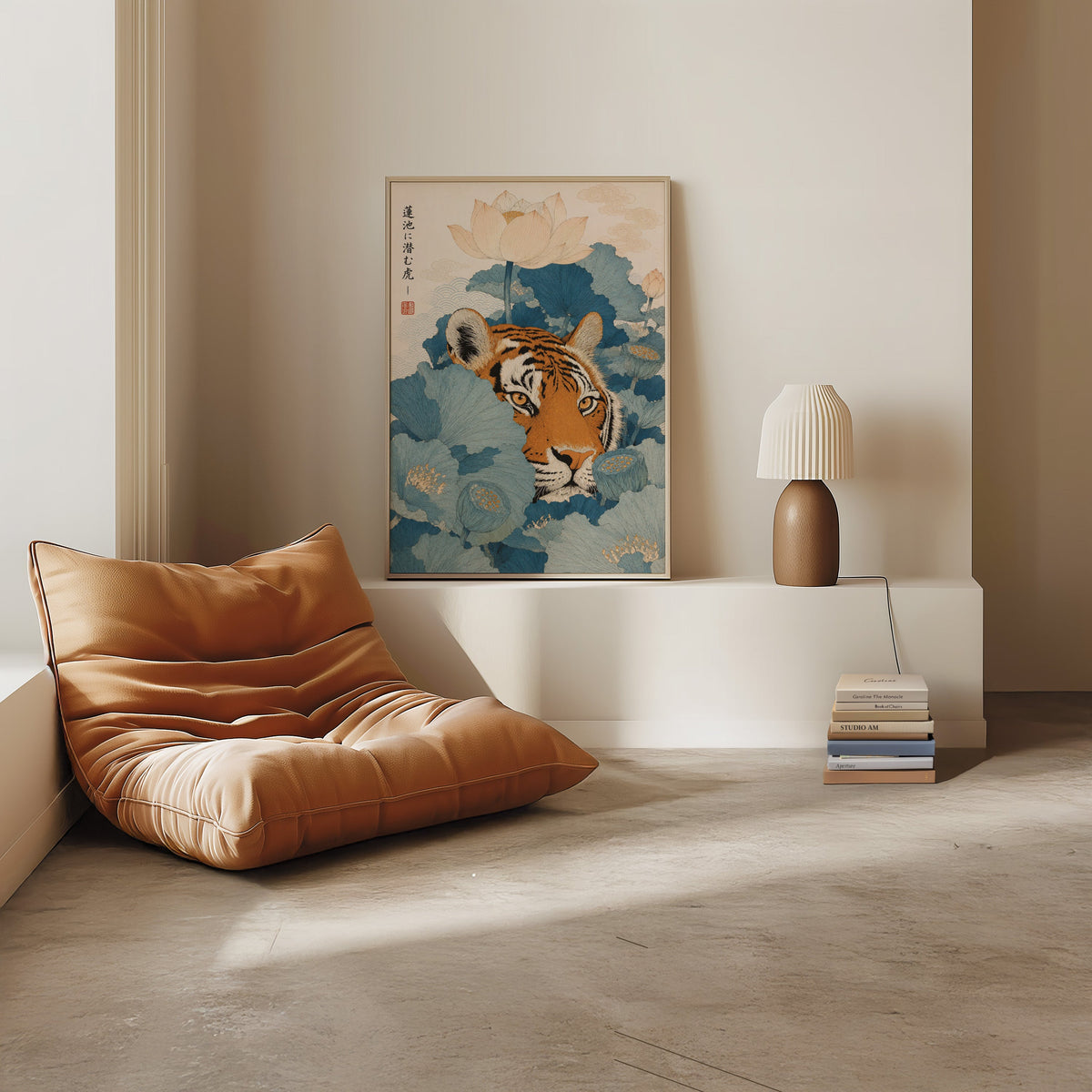 tiger hiding in blue lotus leaves print in a light oak frame on a white ledge by a tan leather floor chair