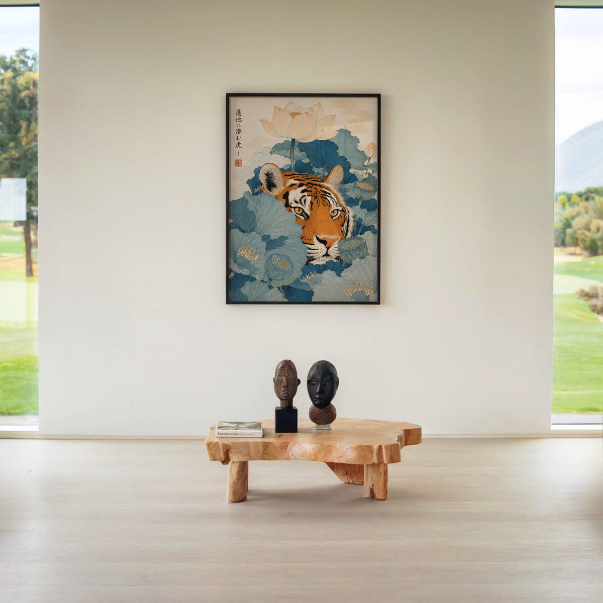 tiger hiding in blue lotus leaves print in a black frame above a live-edge wood coffee table between garden windows