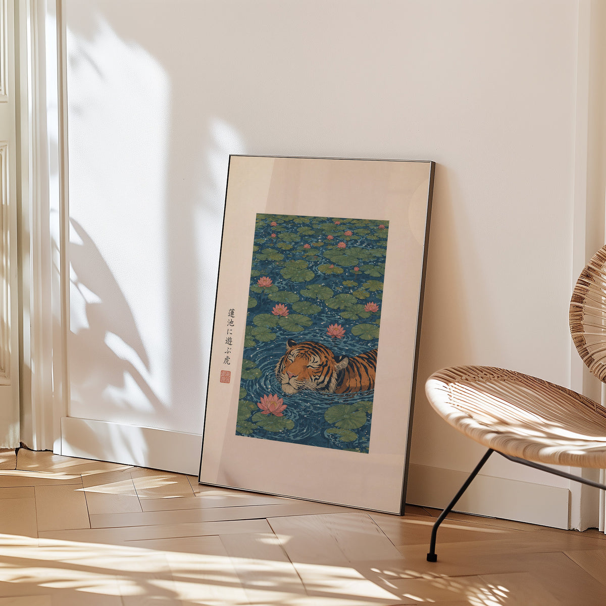 tiger swimming in lotus pond print in a black frame leaning on a herringbone floor beside a woven rattan chair