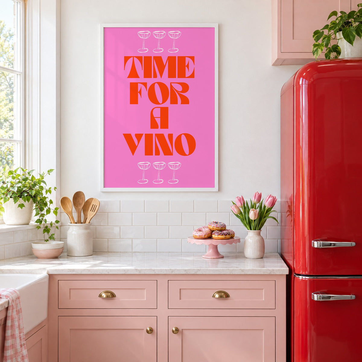Time for a Vino pink coupes print in a white frame in a pink kitchen beside a red retro fridge
