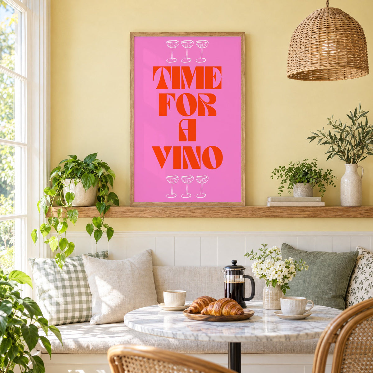Time for a Vino pink coupes print in an oak frame on a picture ledge above a sunny breakfast nook