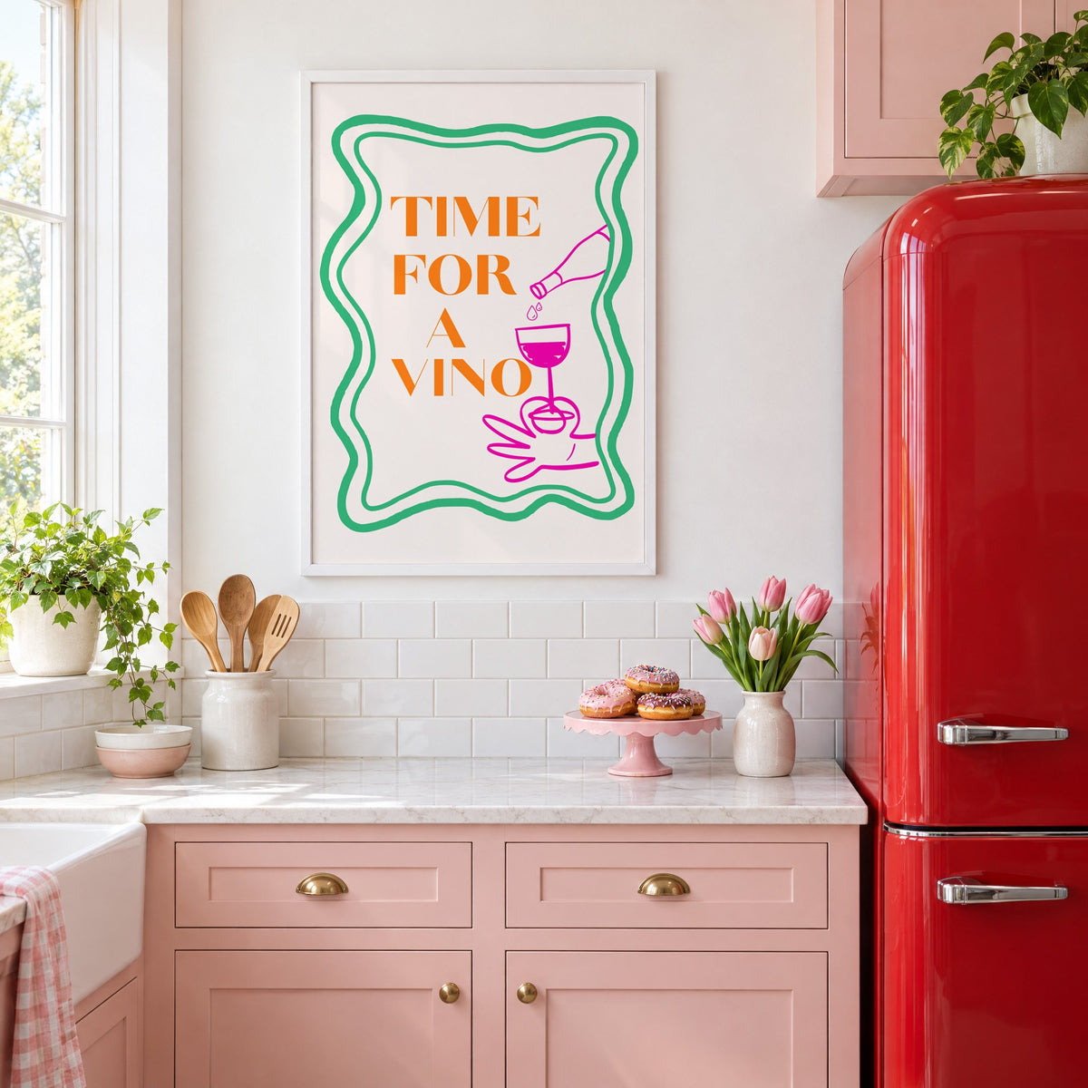 TIME FOR A VINO wine pour wavy frame print in a white frame above pink cabinets beside a red retro fridge