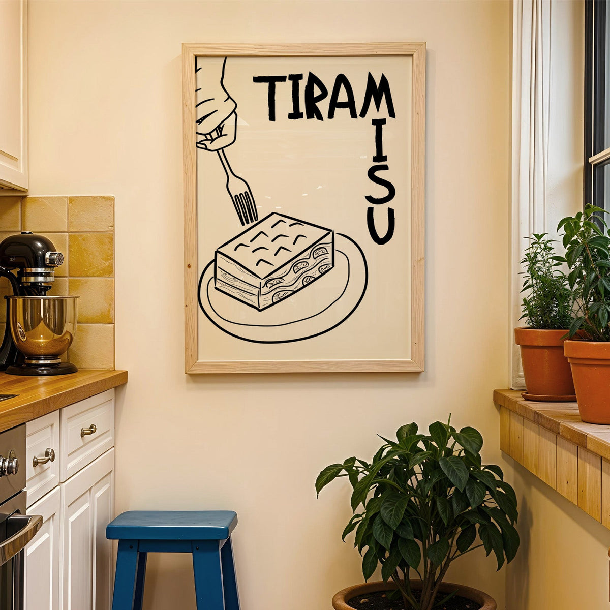 Tiramisu line art print in a wood frame on a yellow tiled kitchen wall