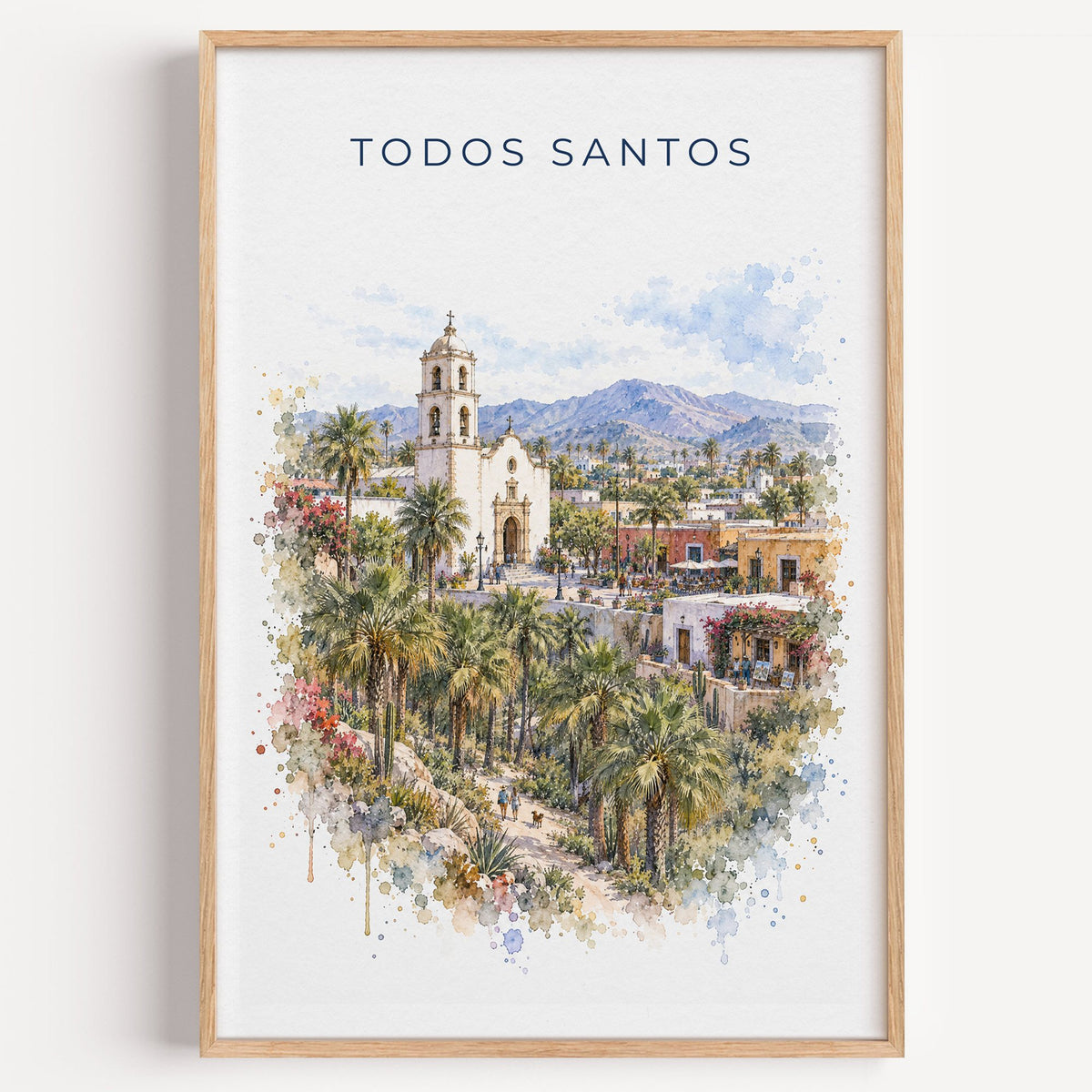 Todos Santos watercolor print in a light oak frame on a plain white wall