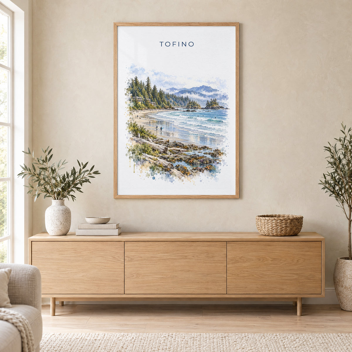 Tofino watercolor print in an oak frame above a light wood sideboard in a Scandinavian living room
