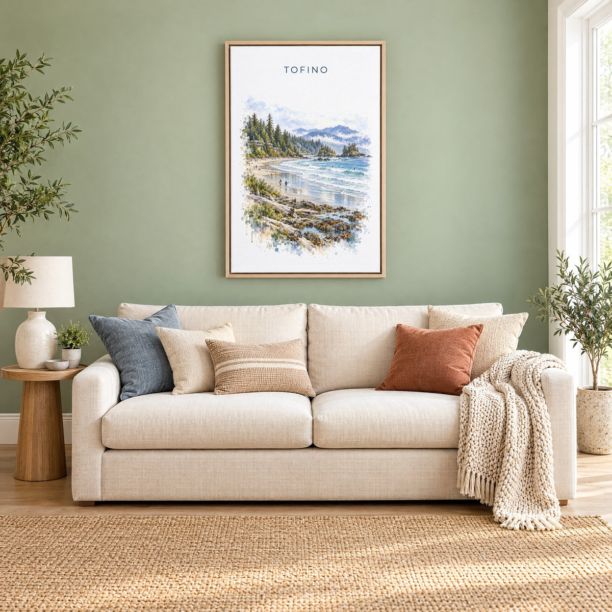 Tofino watercolor print as a natural floater canvas above a cream linen sofa on a sage green wall