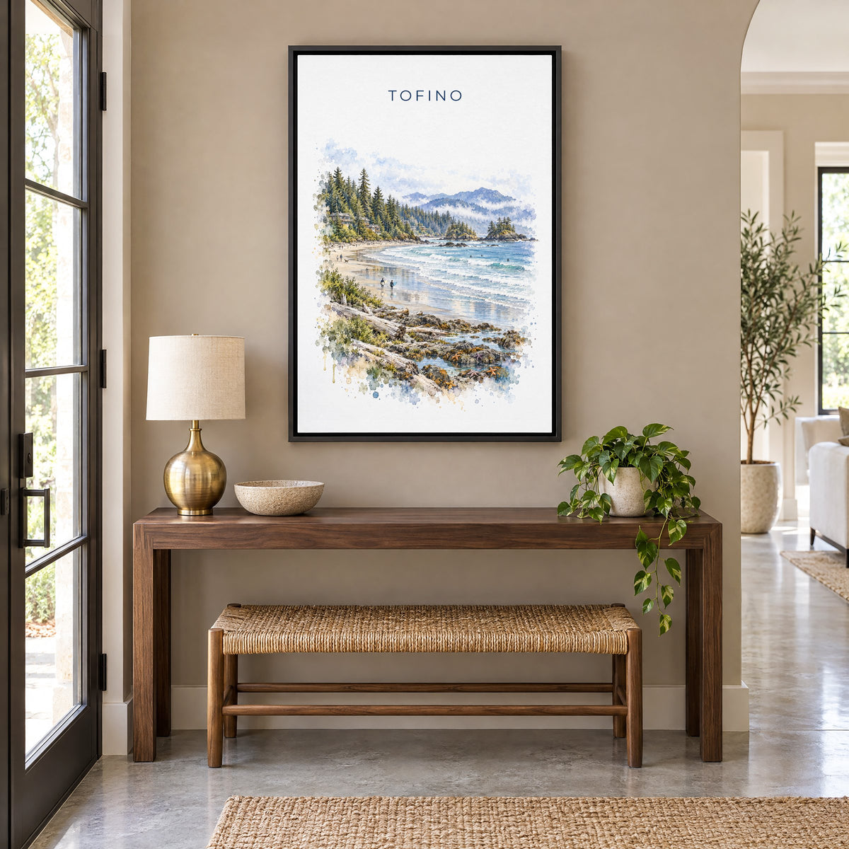 Tofino watercolor print as a black floater canvas above a walnut console and woven bench in an entryway