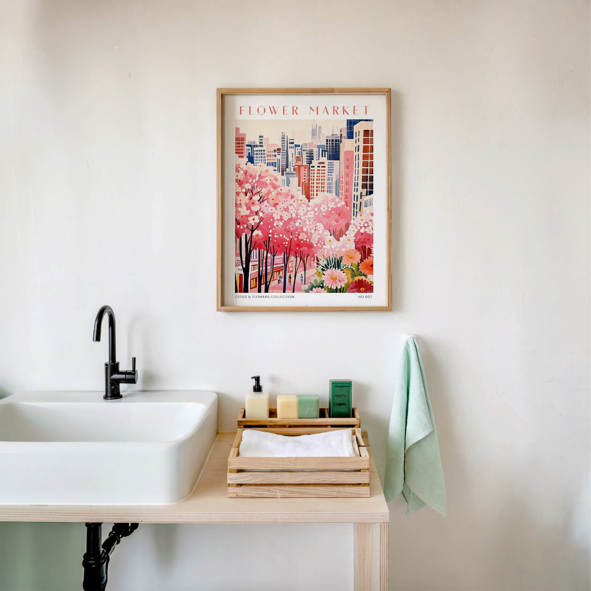 Tokyo flower market print in an oak frame above a white bathroom sink with folded towels
