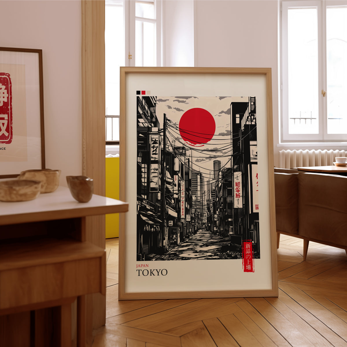 Tokyo ink street with red sun print in an oak frame on the parquet floor of a sunlit living room