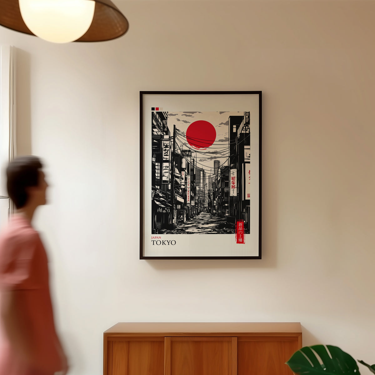 Tokyo ink street with red sun print in a black frame in a hallway under a rattan pendant