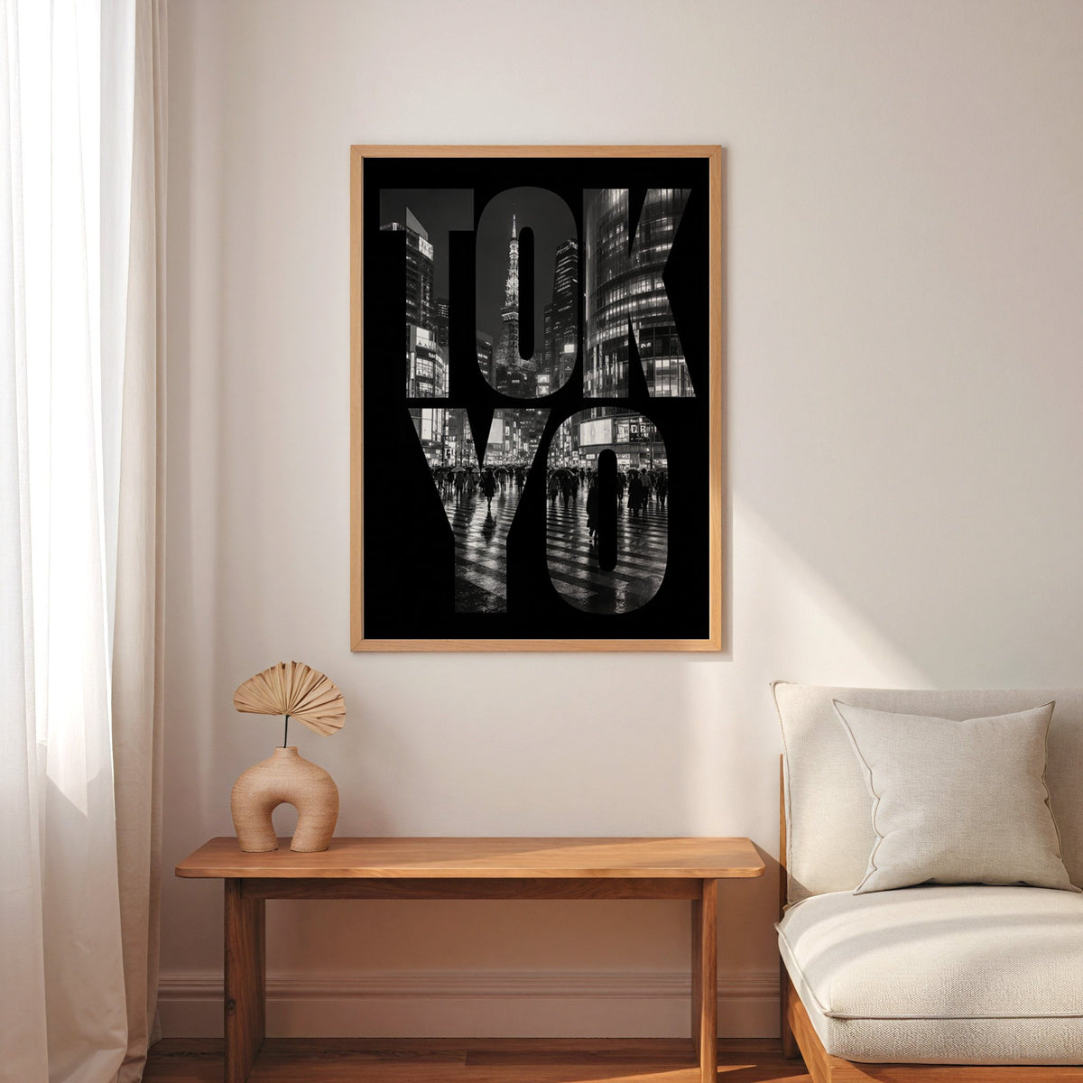 Tokyo letters filled with night city photo print in an oak frame above a narrow console with an arched vase