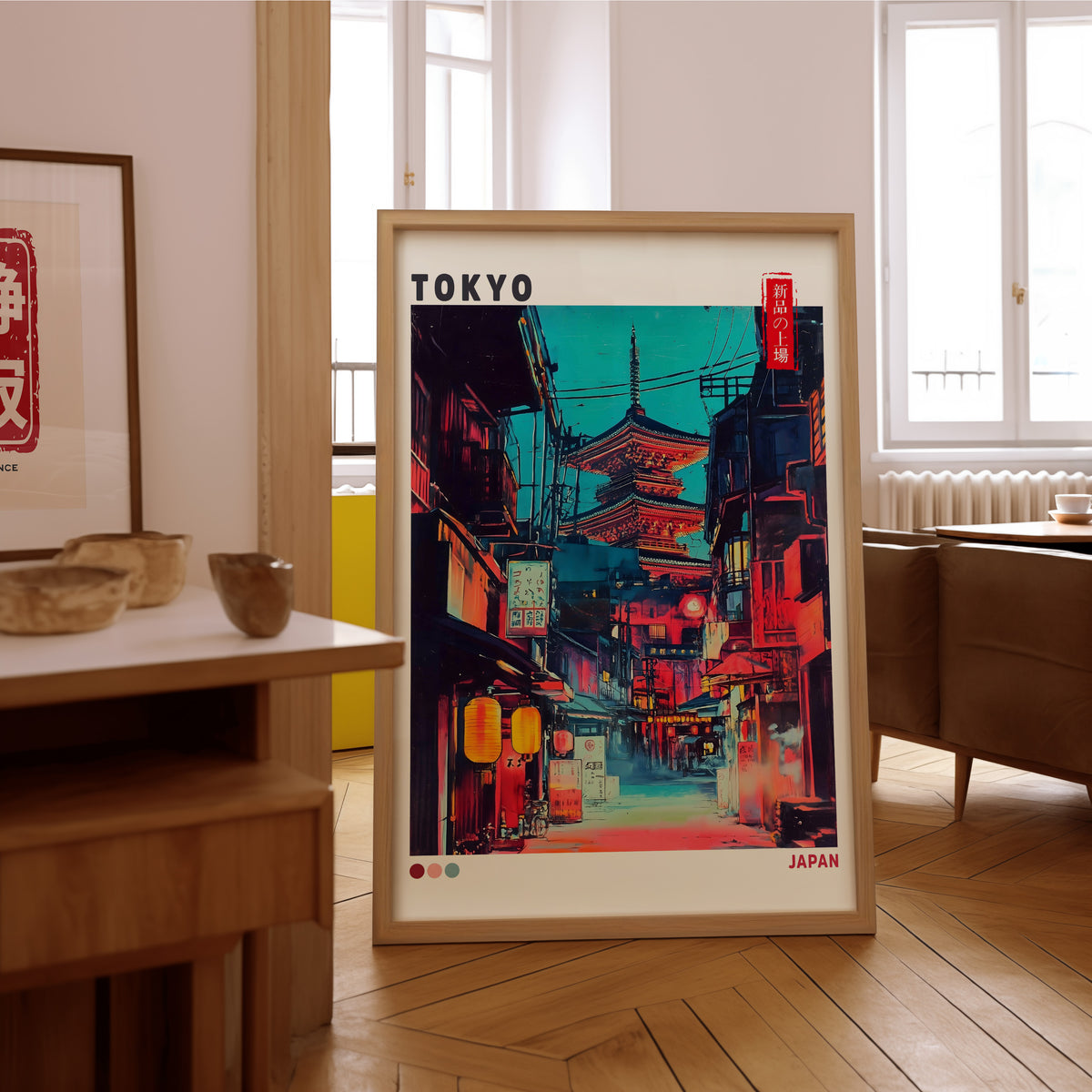 Tokyo neon alley and red pagoda print in an oak frame on the parquet floor of a sunlit living room