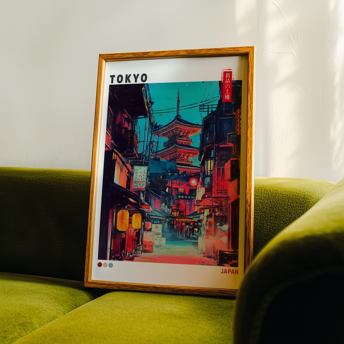 Tokyo neon alley and red pagoda print in an oak frame propped on a green velvet sofa