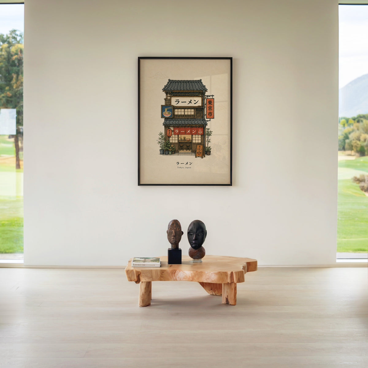 Tokyo ramen shop storefront print in a black frame above a live-edge wood coffee table between garden windows