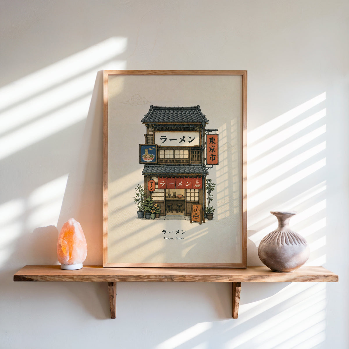Tokyo ramen shop storefront print in an oak frame on a live-edge wall shelf with a salt lamp and clay vase