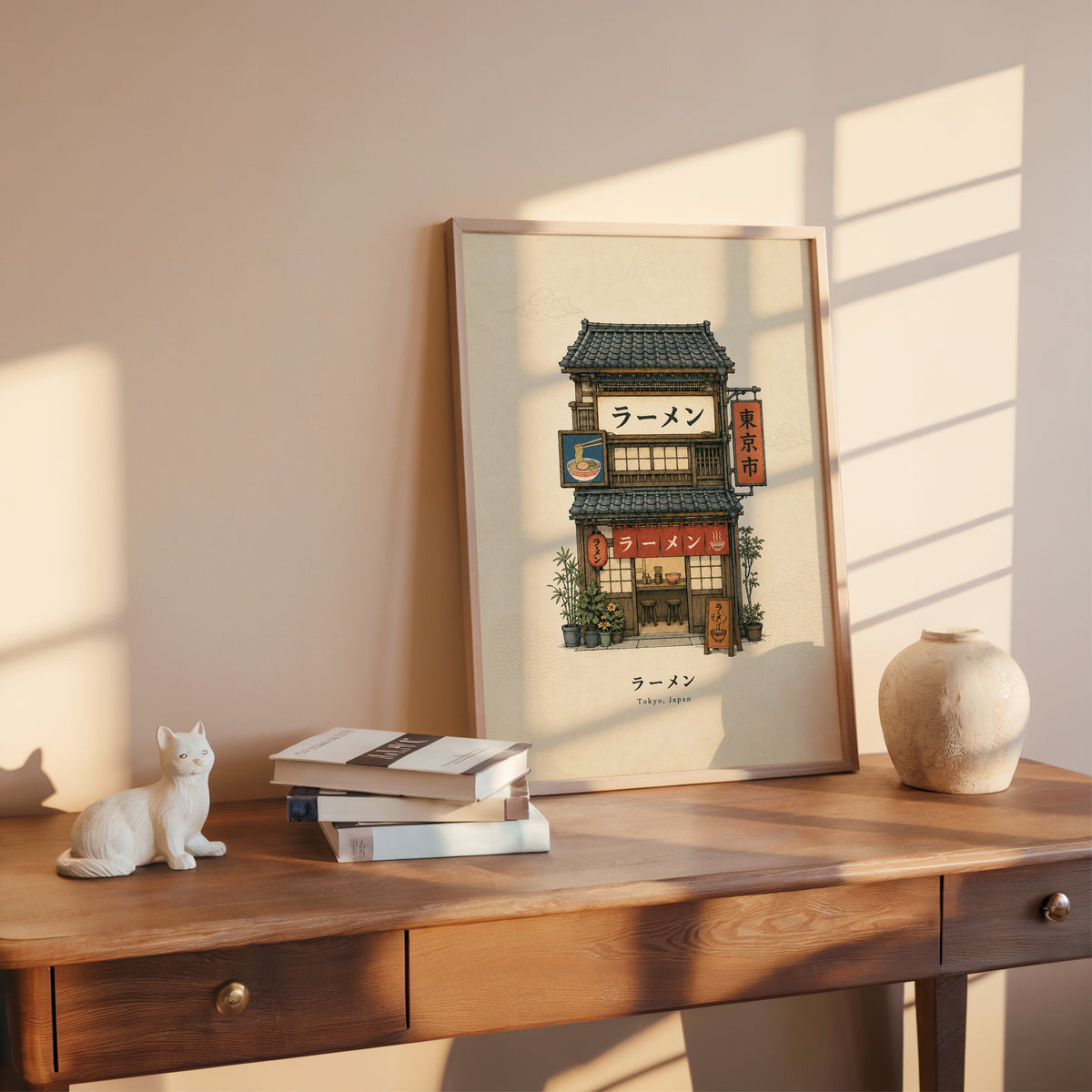 Tokyo ramen shop storefront print shown in a rose gold frame leaning on a wooden writing desk with books