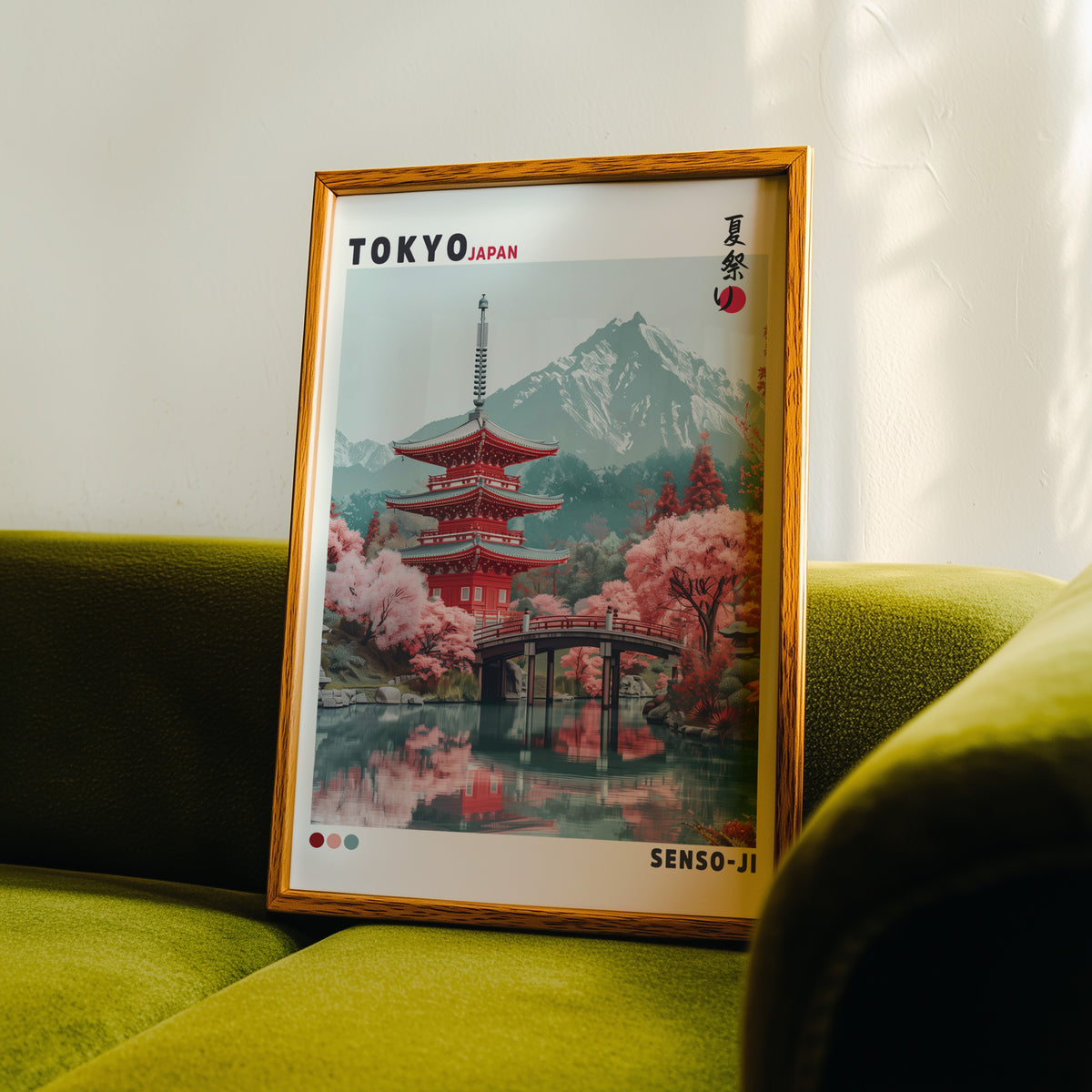 Red pagoda and arched bridge sakura print in an oak frame propped on a green velvet sofa