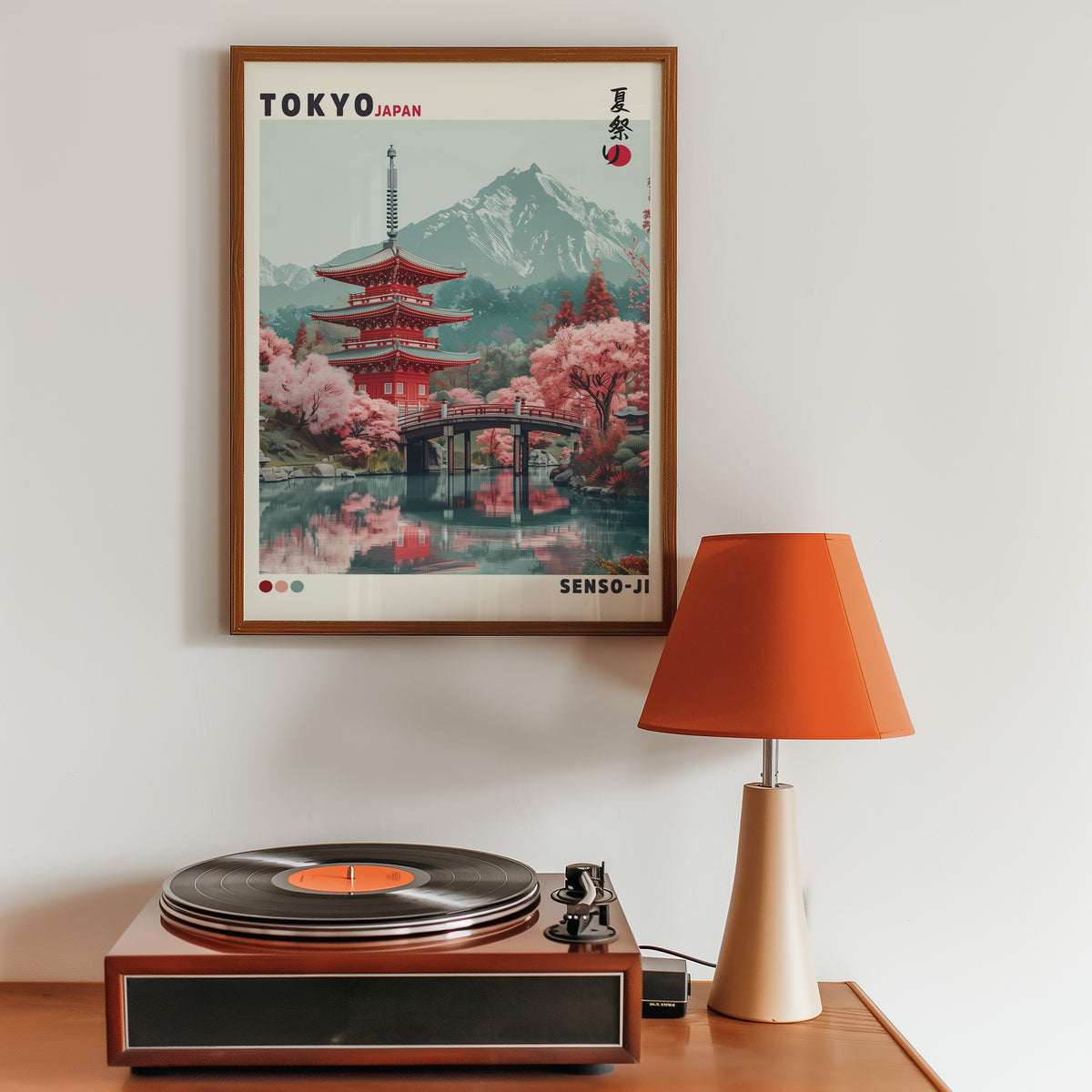 Red pagoda and arched bridge sakura print in a walnut frame above a sideboard with a record player