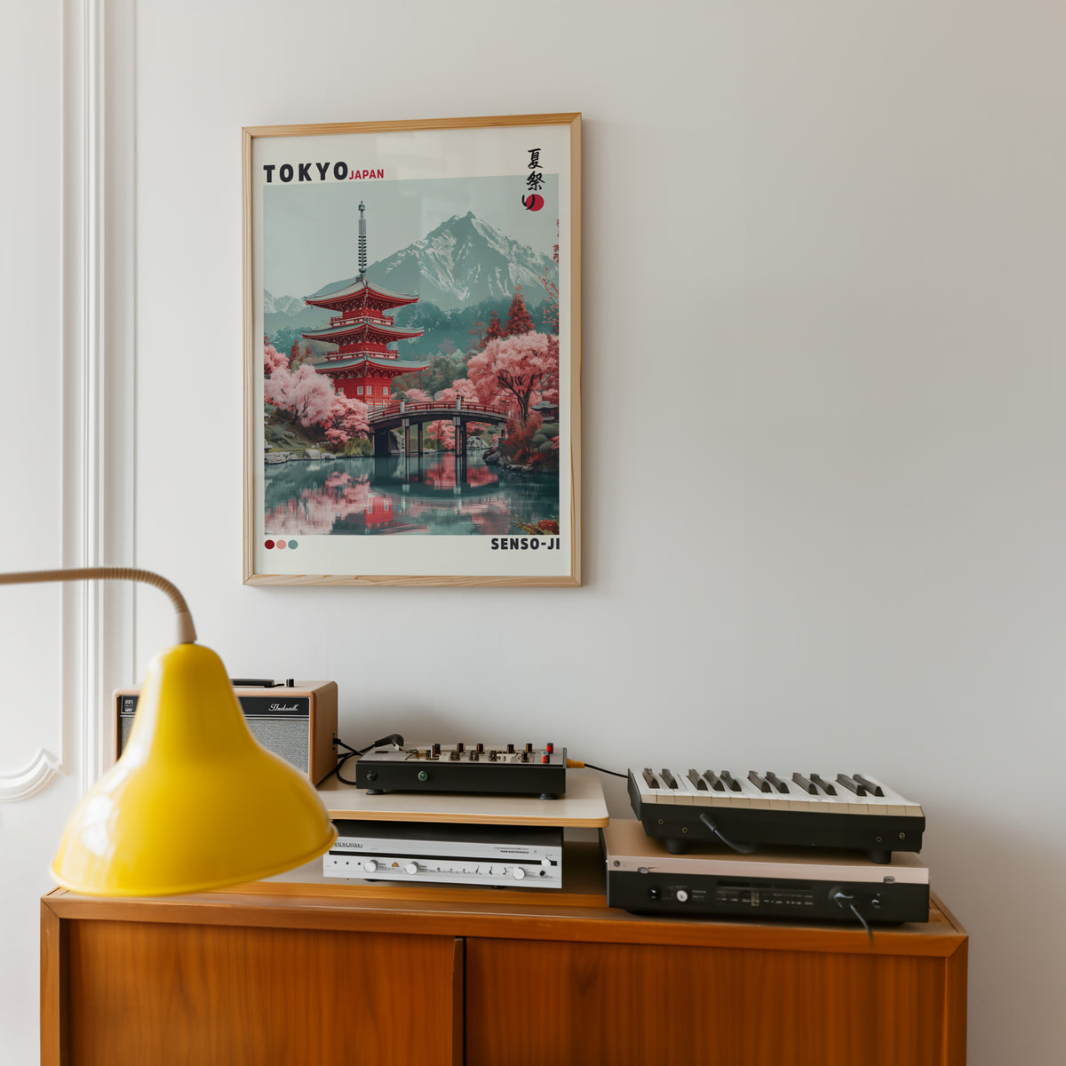 Red pagoda and arched bridge sakura print in an oak frame above a teak sideboard with vintage hi-fi