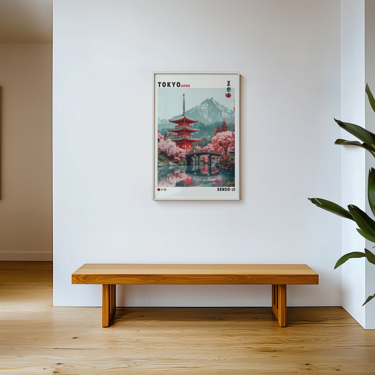 Red pagoda and arched bridge sakura print shown in a white frame above a wooden entryway bench