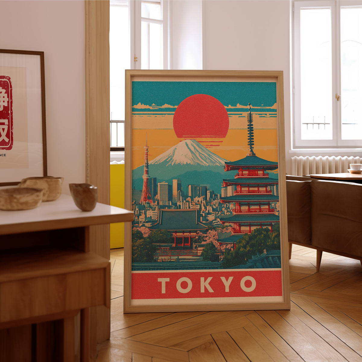 Retro Tokyo red sun skyline print in an oak frame on the parquet floor of a sunlit living room