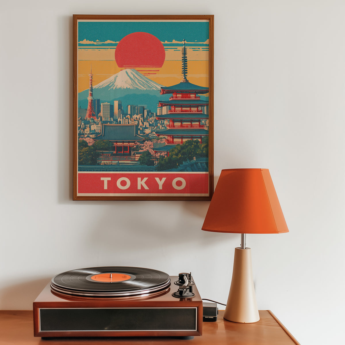 Retro Tokyo red sun skyline print in a walnut frame above a sideboard with a record player
