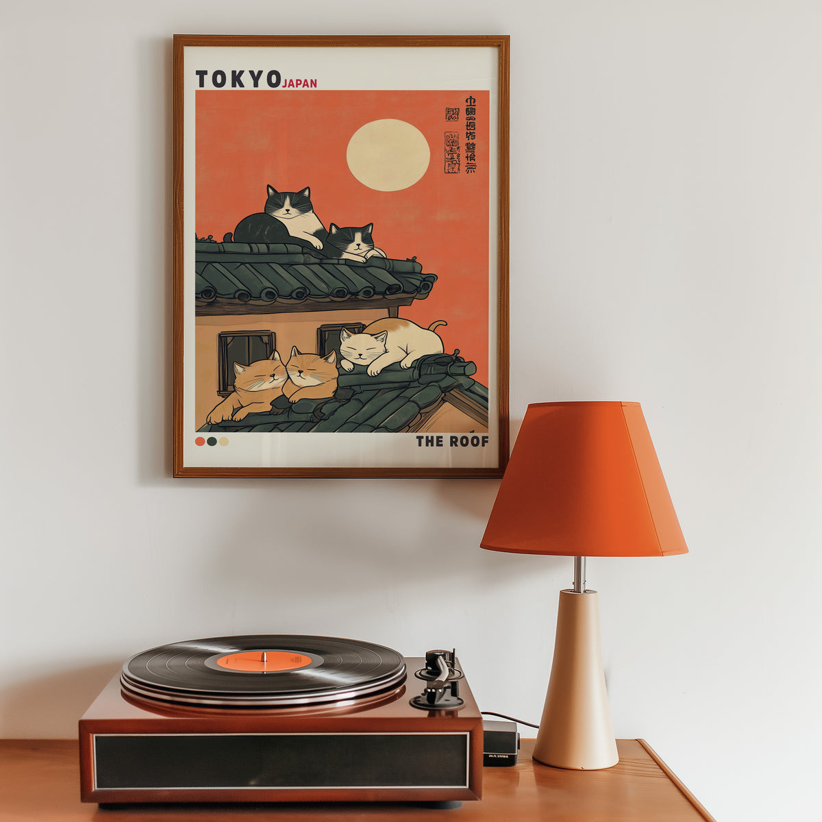 Five cats sleeping on Tokyo roof print in a walnut frame above a sideboard with a record player