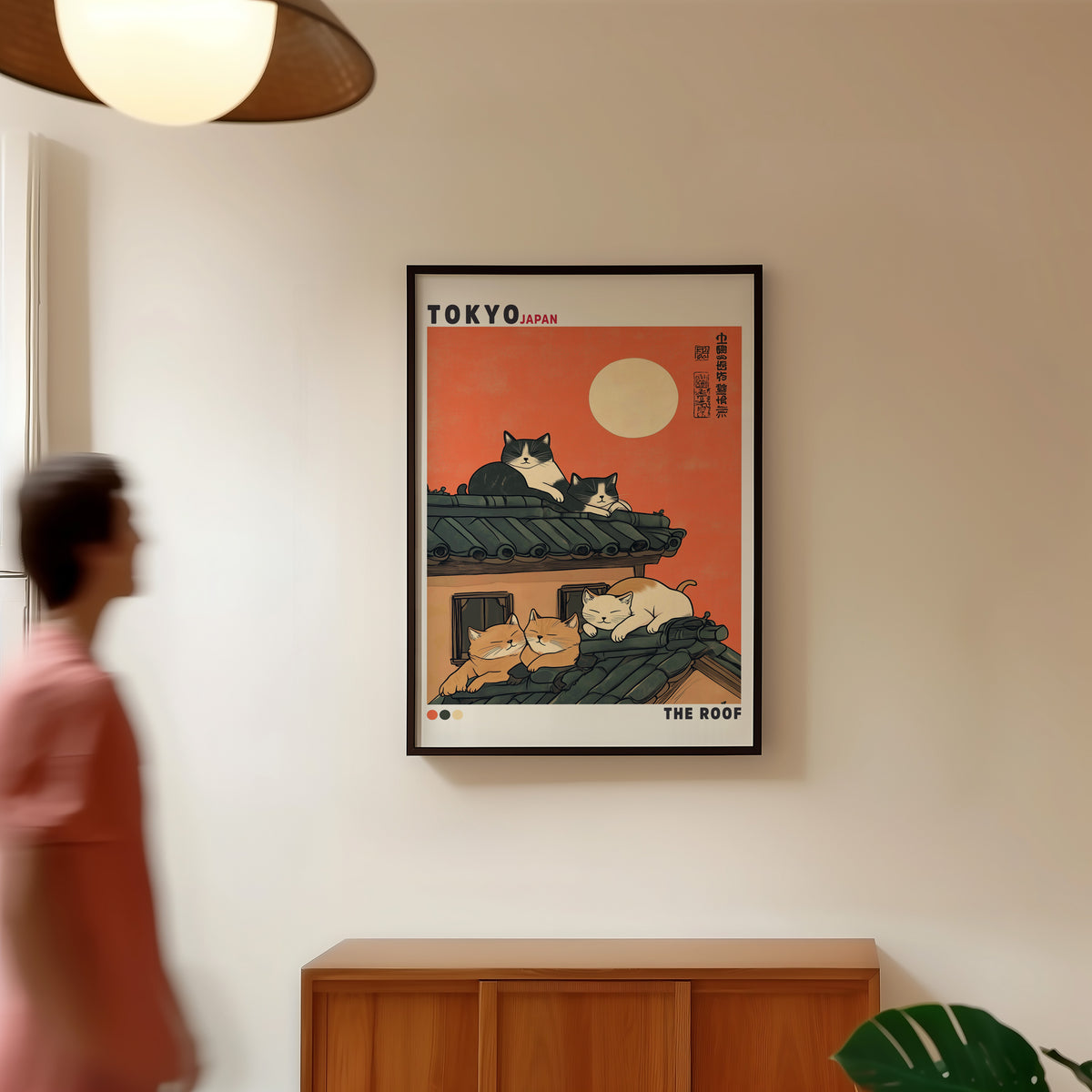 Five cats sleeping on Tokyo roof print in a black frame in a hallway under a rattan pendant