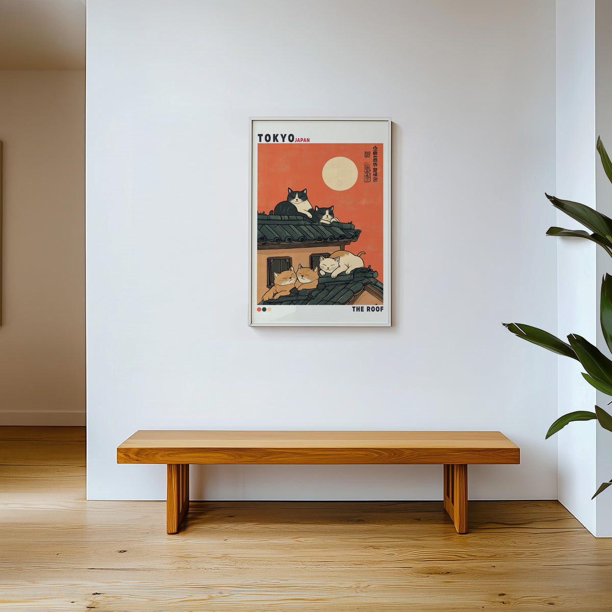 Five cats sleeping on Tokyo roof print shown in a white frame above a wooden entryway bench