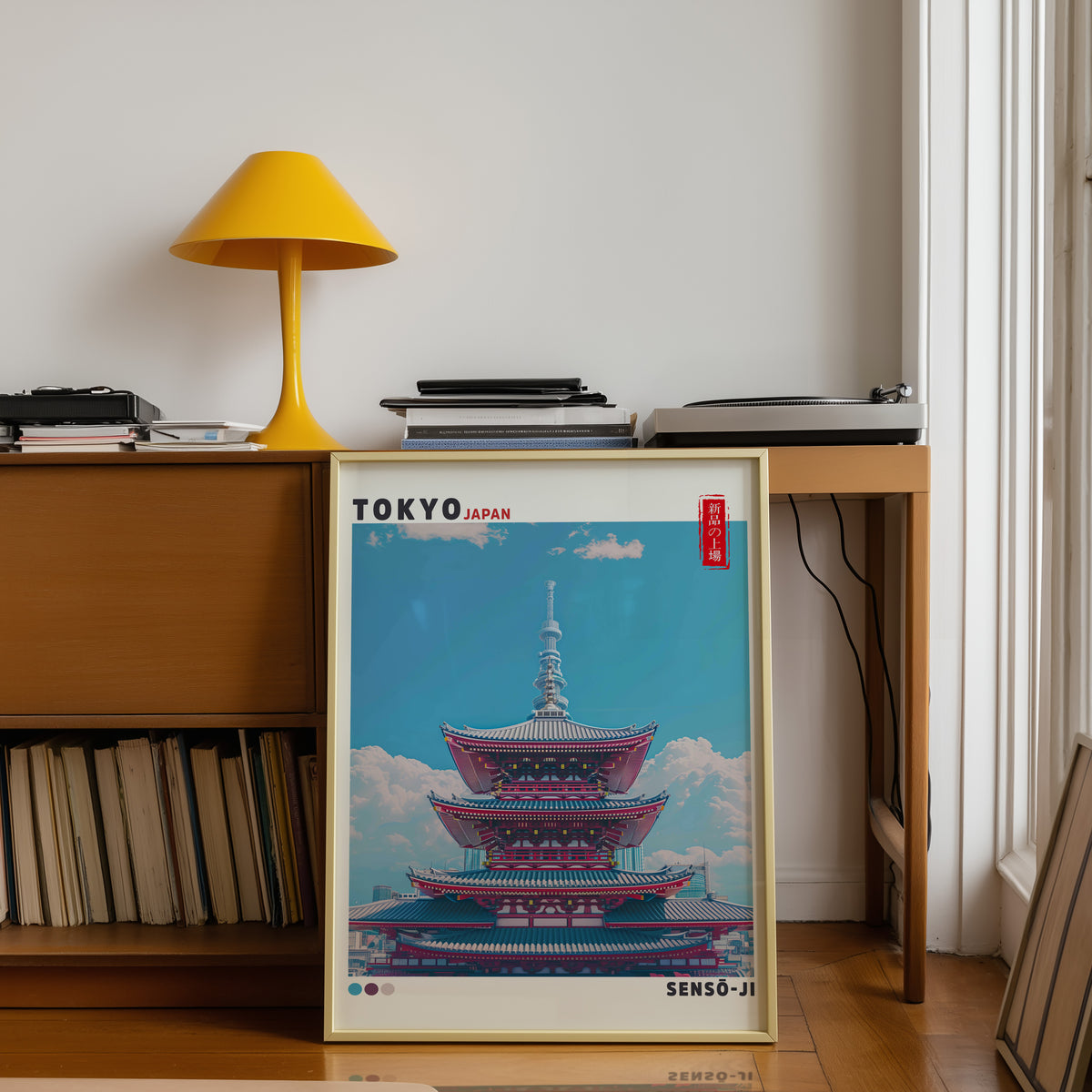 Senso-ji five-story pagoda print shown in a gold frame below a teak desk with a yellow lamp