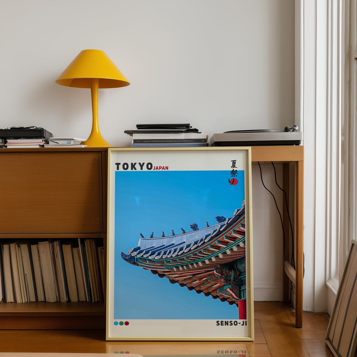 Senso-ji green temple roof detail print shown in a gold frame below a teak desk with a yellow lamp