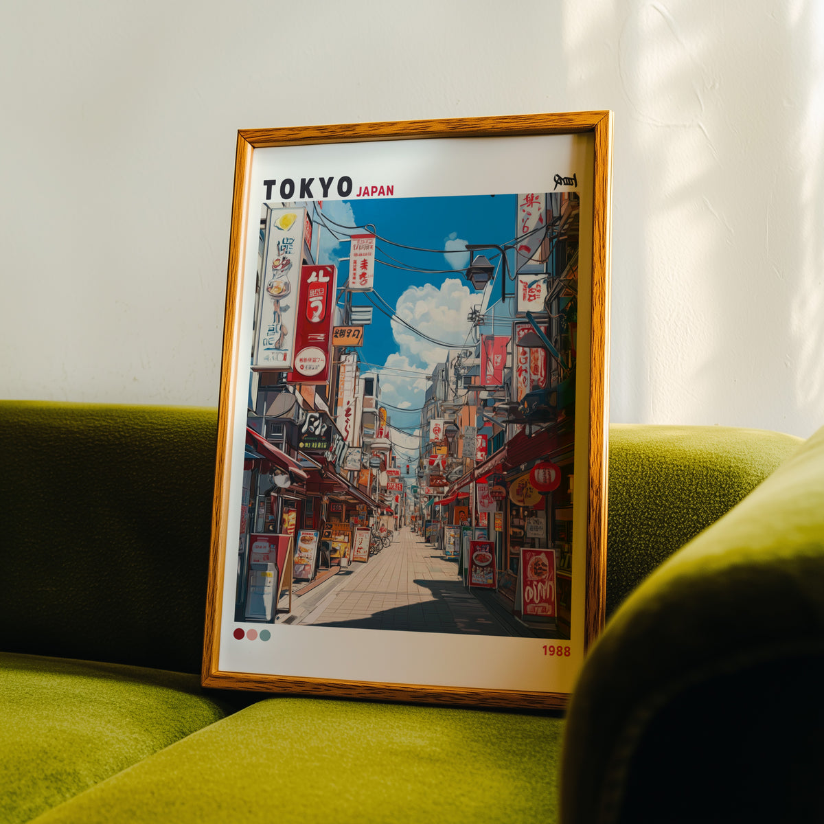 Tokyo shopping street 1988 print in an oak frame propped on a green velvet sofa