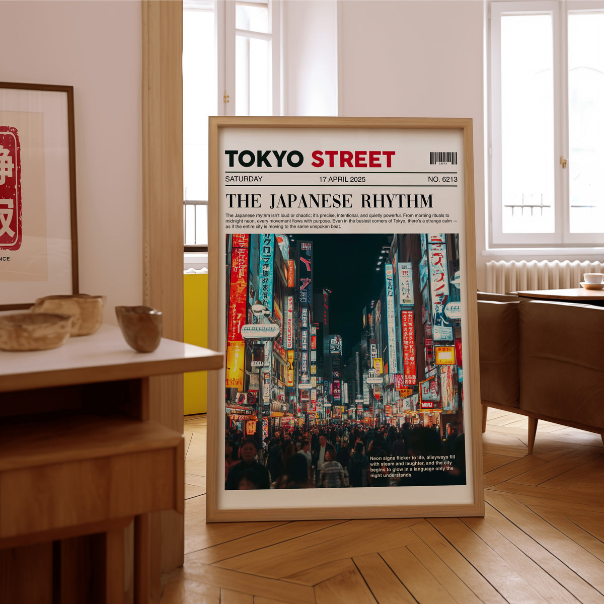 Tokyo street neon newspaper print in an oak frame on the parquet floor of a sunlit living room